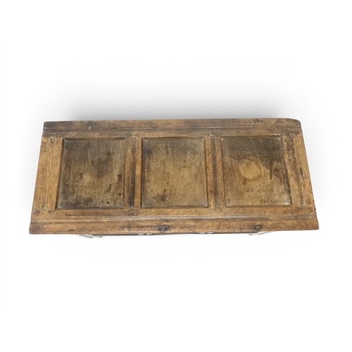2022 - A 17TH/18TH CENTURY OAK BLANKET CHESTwith three panel lid with wrought iron fitting over carved thre... 