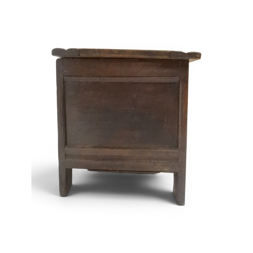 2022 - A 17TH/18TH CENTURY OAK BLANKET CHESTwith three panel lid with wrought iron fitting over carved thre... 