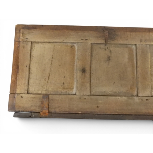 2022 - A 17TH/18TH CENTURY OAK BLANKET CHESTwith three panel lid with wrought iron fitting over carved thre... 