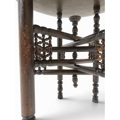 2023 - A 19TH/20TH CENTURY MOORISH COPPER TRAY TOP FOLDING TABLEcircular copper top with raised gallery edg... 