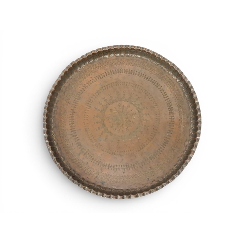 2023 - A 19TH/20TH CENTURY MOORISH COPPER TRAY TOP FOLDING TABLEcircular copper top with raised gallery edg... 