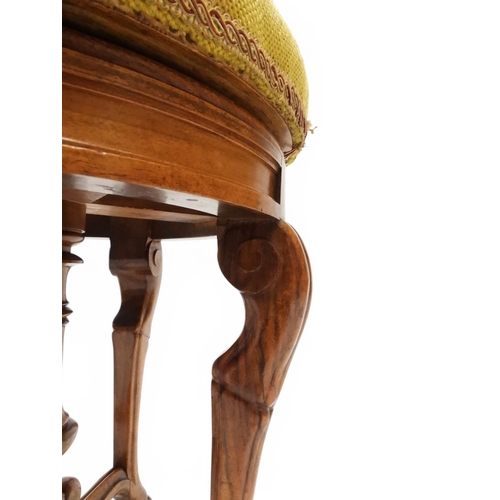 2027 - A PAIR OF 19TH CENTURY WALNUT RISE AND FALL PIANO STOOLS&nbsp;with circular mustard floral tapestry ... 