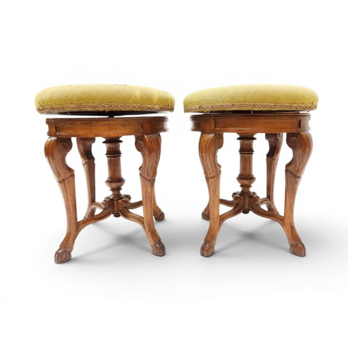 2027 - A PAIR OF 19TH CENTURY WALNUT RISE AND FALL PIANO STOOLS&nbsp;with circular mustard floral tapestry ... 