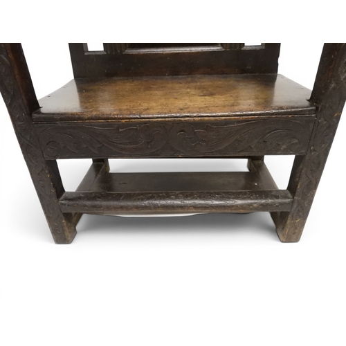 2029 - A 19TH CENTURY OAK WAINSCOT STYLE OAK ARMCHAIR&nbsp;with carved panel back depicting a monk tasting ... 