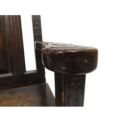 2029 - A 19TH CENTURY OAK WAINSCOT STYLE OAK ARMCHAIR&nbsp;with carved panel back depicting a monk tasting ... 