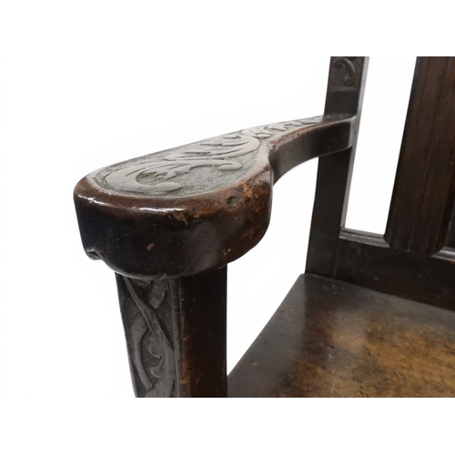 2029 - A 19TH CENTURY OAK WAINSCOT STYLE OAK ARMCHAIR&nbsp;with carved panel back depicting a monk tasting ... 