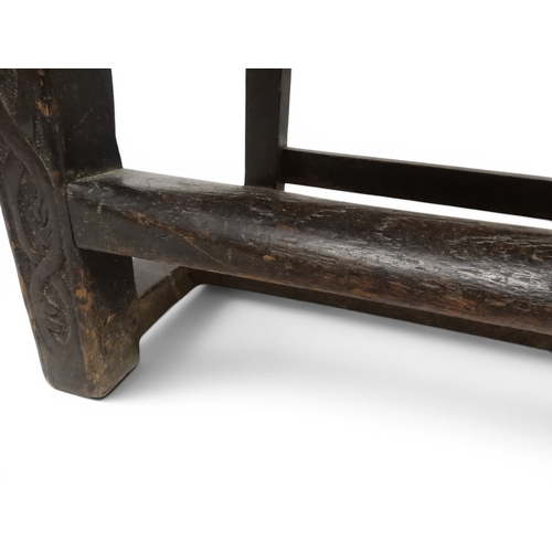 2029 - A 19TH CENTURY OAK WAINSCOT STYLE OAK ARMCHAIR&nbsp;with carved panel back depicting a monk tasting ... 