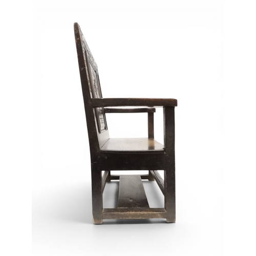 2029 - A 19TH CENTURY OAK WAINSCOT STYLE OAK ARMCHAIR&nbsp;with carved panel back depicting a monk tasting ... 