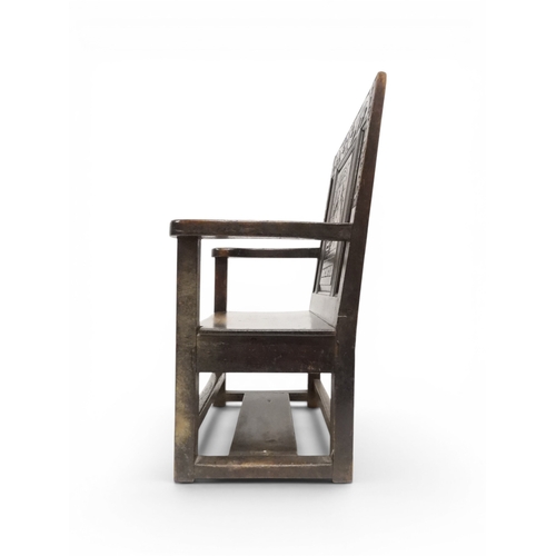 2029 - A 19TH CENTURY OAK WAINSCOT STYLE OAK ARMCHAIR&nbsp;with carved panel back depicting a monk tasting ... 