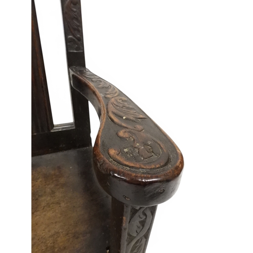 2029 - A 19TH CENTURY OAK WAINSCOT STYLE OAK ARMCHAIR&nbsp;with carved panel back depicting a monk tasting ... 