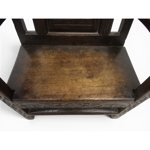 2029 - A 19TH CENTURY OAK WAINSCOT STYLE OAK ARMCHAIR&nbsp;with carved panel back depicting a monk tasting ... 