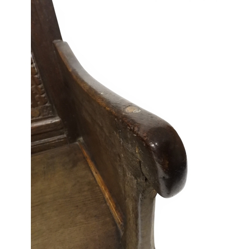 2030 - A 18TH CENTURY OAK WAINSCOT STYLE OAK ARMCHAIR&nbsp;with panel back carved with foliate motifs over ... 