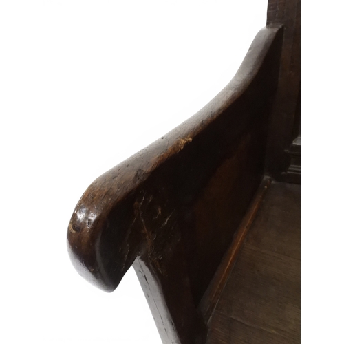 2030 - A 18TH CENTURY OAK WAINSCOT STYLE OAK ARMCHAIR&nbsp;with panel back carved with foliate motifs over ... 