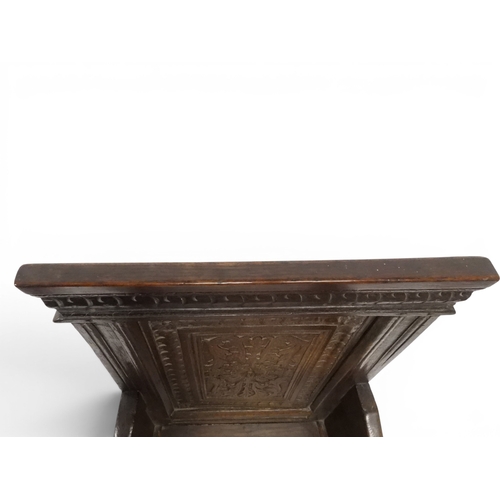 2030 - A 18TH CENTURY OAK WAINSCOT STYLE OAK ARMCHAIR&nbsp;with panel back carved with foliate motifs over ... 