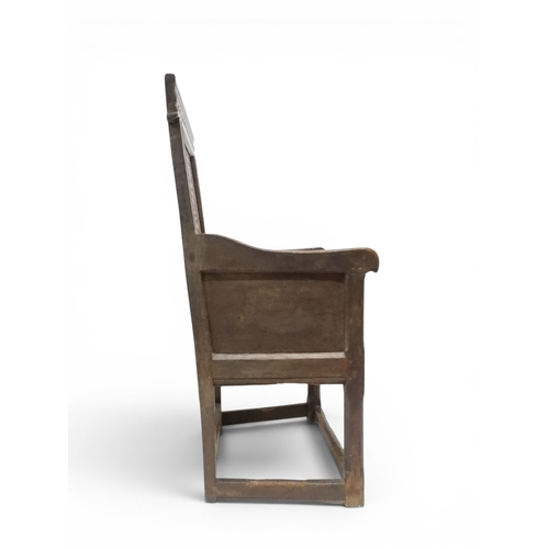2030 - A 18TH CENTURY OAK WAINSCOT STYLE OAK ARMCHAIR&nbsp;with panel back carved with foliate motifs over ... 