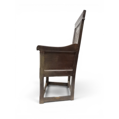 2030 - A 18TH CENTURY OAK WAINSCOT STYLE OAK ARMCHAIR&nbsp;with panel back carved with foliate motifs over ... 