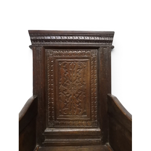 2030 - A 18TH CENTURY OAK WAINSCOT STYLE OAK ARMCHAIR&nbsp;with panel back carved with foliate motifs over ... 