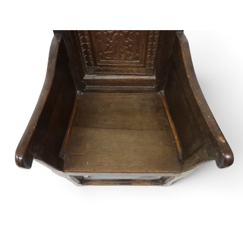 2030 - A 18TH CENTURY OAK WAINSCOT STYLE OAK ARMCHAIR&nbsp;with panel back carved with foliate motifs over ... 