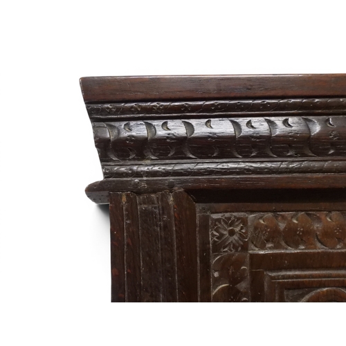 2030 - A 18TH CENTURY OAK WAINSCOT STYLE OAK ARMCHAIR&nbsp;with panel back carved with foliate motifs over ... 