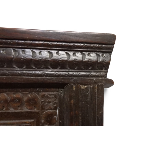 2030 - A 18TH CENTURY OAK WAINSCOT STYLE OAK ARMCHAIR&nbsp;with panel back carved with foliate motifs over ... 