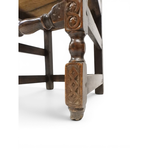 2031 - A PAIR OF 17TH CENTURY STYLE OAK HALL CHAIRS with floral carved panel backs surmounted with twinned ... 