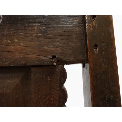 2031 - A PAIR OF 17TH CENTURY STYLE OAK HALL CHAIRS with floral carved panel backs surmounted with twinned ... 
