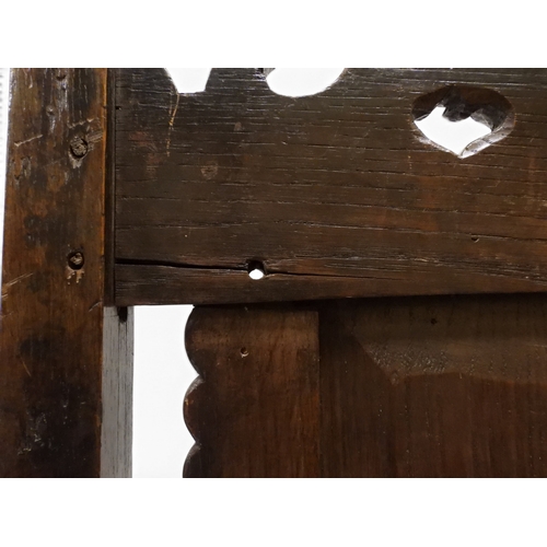 2031 - A PAIR OF 17TH CENTURY STYLE OAK HALL CHAIRS with floral carved panel backs surmounted with twinned ... 