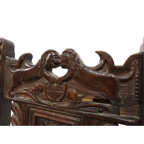 2031 - A PAIR OF 17TH CENTURY STYLE OAK HALL CHAIRS with floral carved panel backs surmounted with twinned ... 