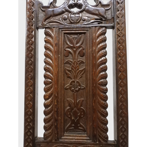 2031 - A PAIR OF 17TH CENTURY STYLE OAK HALL CHAIRS with floral carved panel backs surmounted with twinned ... 