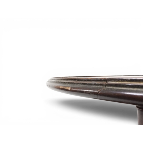 2037 - A GEORGIAN MAHOGANY TWO TIER DUMB WAITERwith two circular drop side tiers of graduating size on turn... 