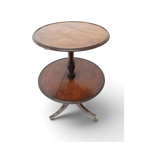 2037 - A GEORGIAN MAHOGANY TWO TIER DUMB WAITERwith two circular drop side tiers of graduating size on turn... 