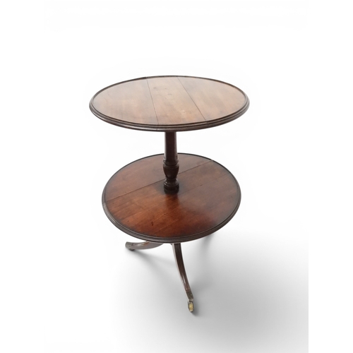 2037 - A GEORGIAN MAHOGANY TWO TIER DUMB WAITERwith two circular drop side tiers of graduating size on turn... 