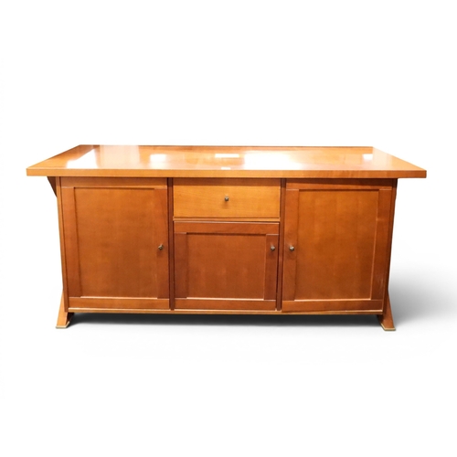 39 - A late 20th century cherry wood sideboard with single central drawer and cabinet door flanked by lar...
