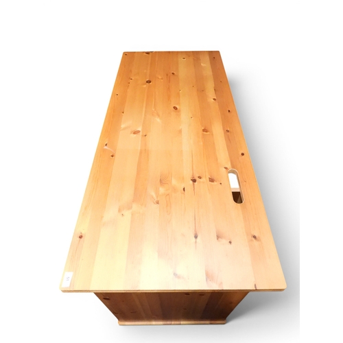 40 - A late 20th century pine computer desk with slide out keyboard shelf flanked by open pedestals, 76cm...
