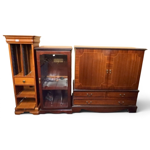 41 - A lot comprising a mahogany veneered two door media cabinet, glass doored stereo cabinet and a mahog...