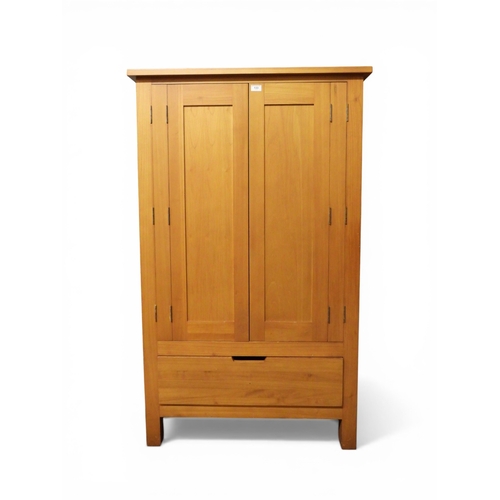 42 - A contemporary teak media cabinet with two double hinged doors concealing fitted interior over singl...