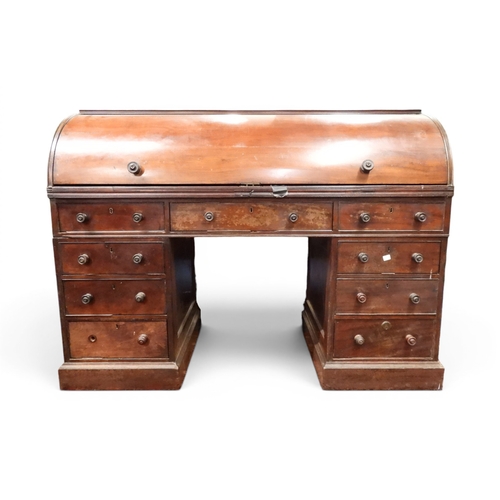 1 - A 19th century mahogany cylinder topped pedestal writing desk, cylinder top concealing pitted writin...