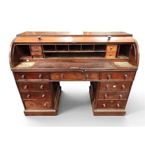 1 - A 19th century mahogany cylinder topped pedestal writing desk, cylinder top concealing pitted writin...