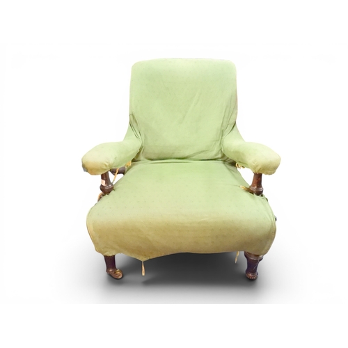 11 - A 19th century mahogany framed slipper armchair with green fabric covering over ecru base fabric uph...