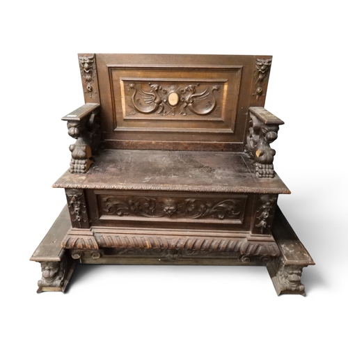 15 - A lot comprising a 19th century oak hall settle with carved panel back over arms carved in the form ...