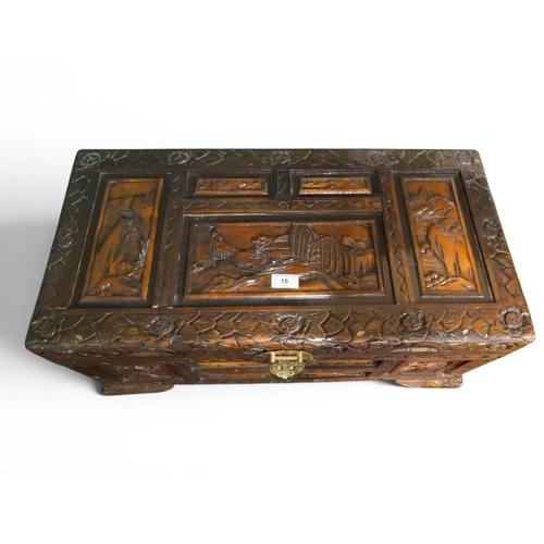16 - An early 20th century Chinese hardwood chest carved on all sides with mountainous scenes within foli...
