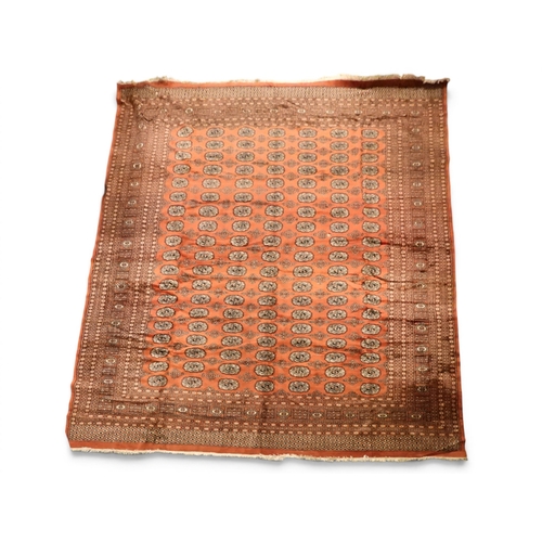 2 - A large terracotta ground Tekke rug with ground decorated with seven rows of nineteen lozenges withi...