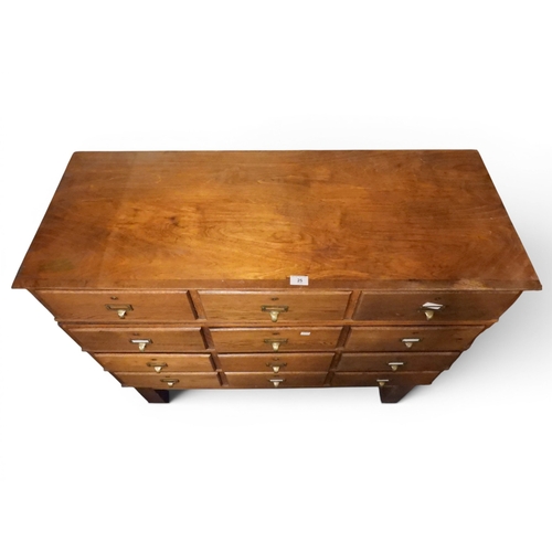 25 - An early 20th century oak index card chest with four rows of three index drawer with brass drawer pu...