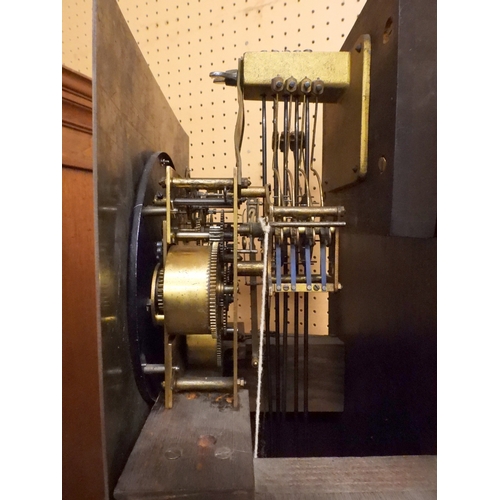27 - An early 20th century oak cased Ingersoll longcase clock with brass dial bearing Arabic and Roman nu...