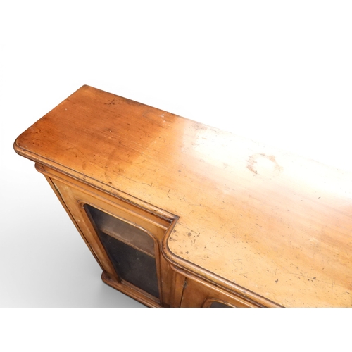 28 - A Victorian mahogany veneered breakfront bookcase with pair of central glazed doors flanked by furth...