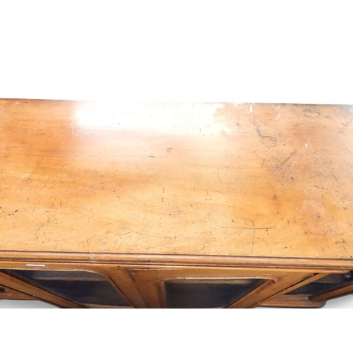 28 - A Victorian mahogany veneered breakfront bookcase with pair of central glazed doors flanked by furth...