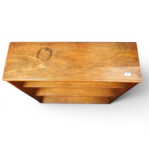 35 - A lot comprising an oak open bookcase, 96cm high x 88cm wide x 29cm deep, a smaller narrow oak open ...