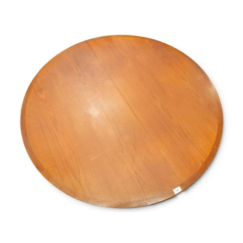 36 - A mid 20th century teak Scandinavian style circular extending dining table with two additional leave...
