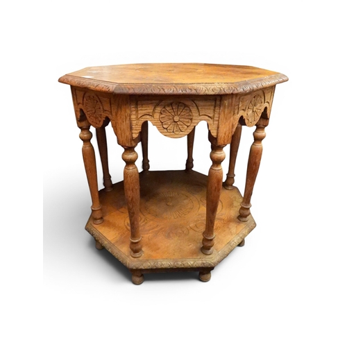 45 - An early 20th century blonde oak octagonal two tier window table with turned uprights and supports, ...
