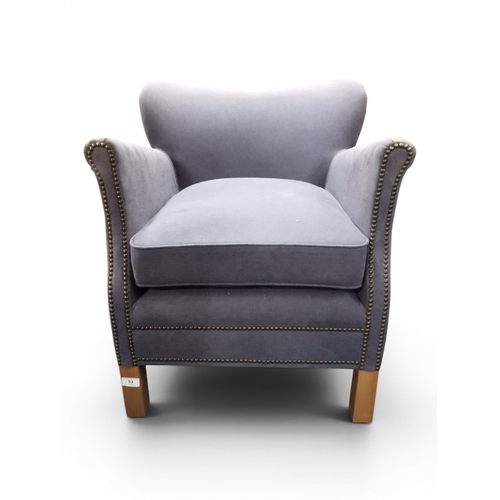 53 - A 20th century Halo blue upholstered tub armchair on beech square front supports, 63cm high x 68cm w...